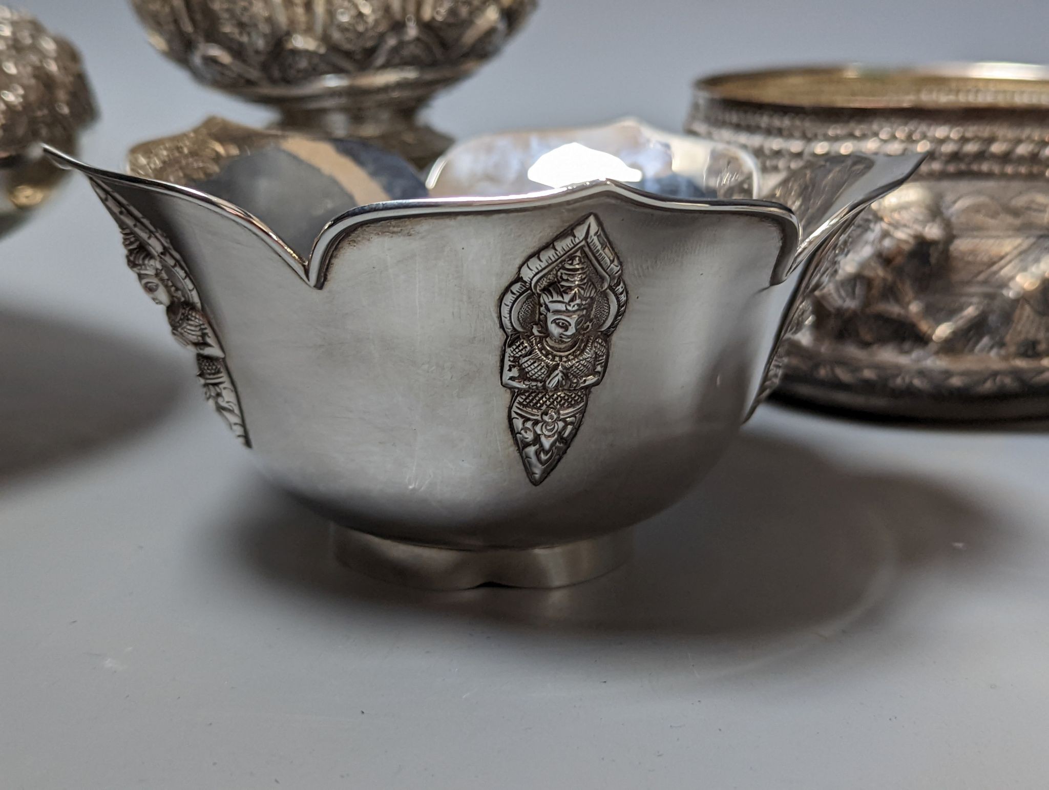 Six assorted embossed white metal bowls, including Indian and Thai, tallest 13.6cm.